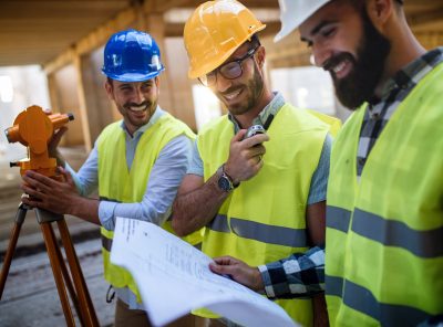 Construction concept of engineer and architect working at construction site with blueprint